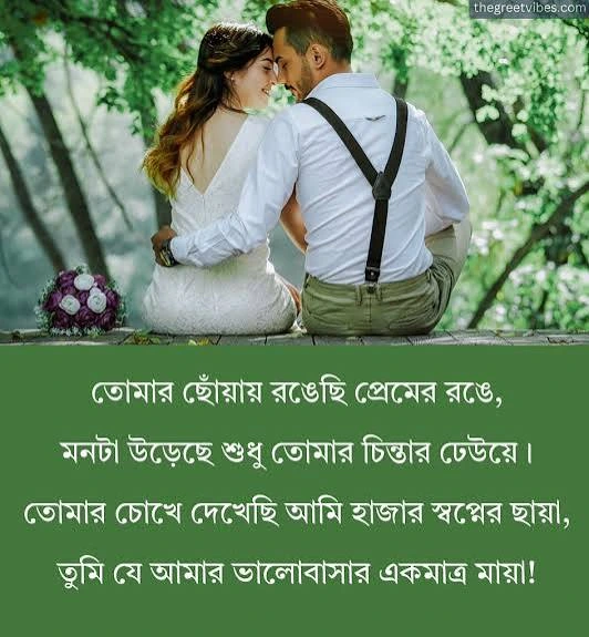 Bengali-Love-Shayari: An image featuring a romantic couple sitting close together outdoors against a backdrop of lush green trees, above a solid green section containing Bengali poetic text.