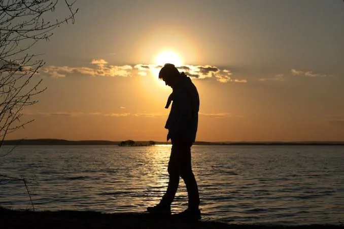Breakup Attitude Shayari showing a confident person standing alone after a breakup at sunset