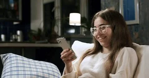 Funny Shayari On Girls Attitude showing a stylish woman laughing while holding a vintage phone indoors