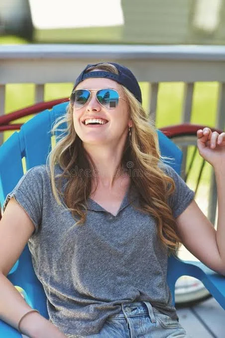 Funny Shayari On Girls Attitude showing a stylish woman laughing outdoors while holding sunglasses