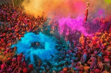 Holi Sad Shayari In Hindi showing a group of people covered in colorful Holi paint during the festival