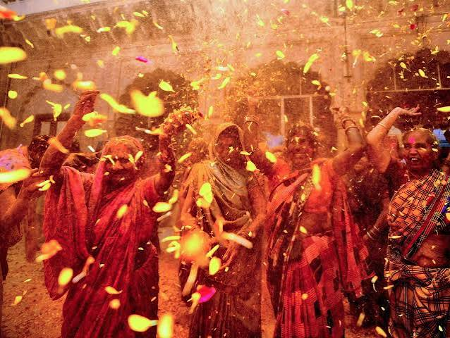 Holi Sad Shayari In Hindi showing women celebrating the colorful Holi festival in Barsana India
