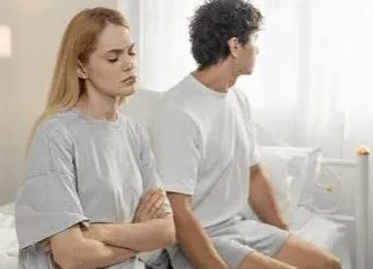 Husband Wife Sad Shayari showing a husband and wife sitting silently together after an argument