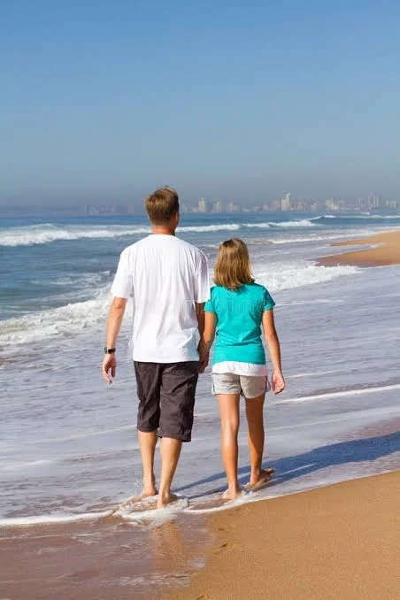 Papa Beti Shayari showing a father and daughter enjoying a peaceful beach walk together